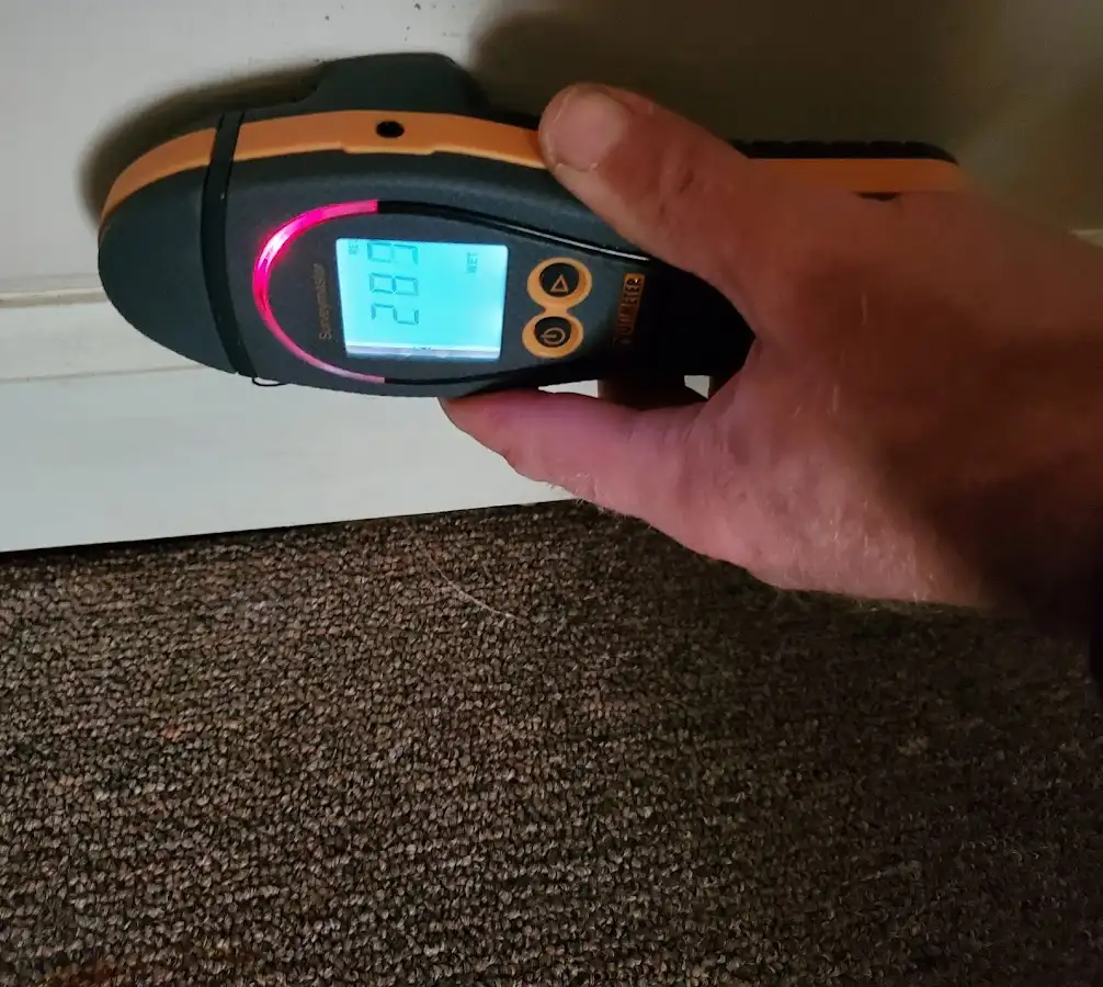 Moisture detection at baseboard during Storm Damage Restoration in Fishersville
